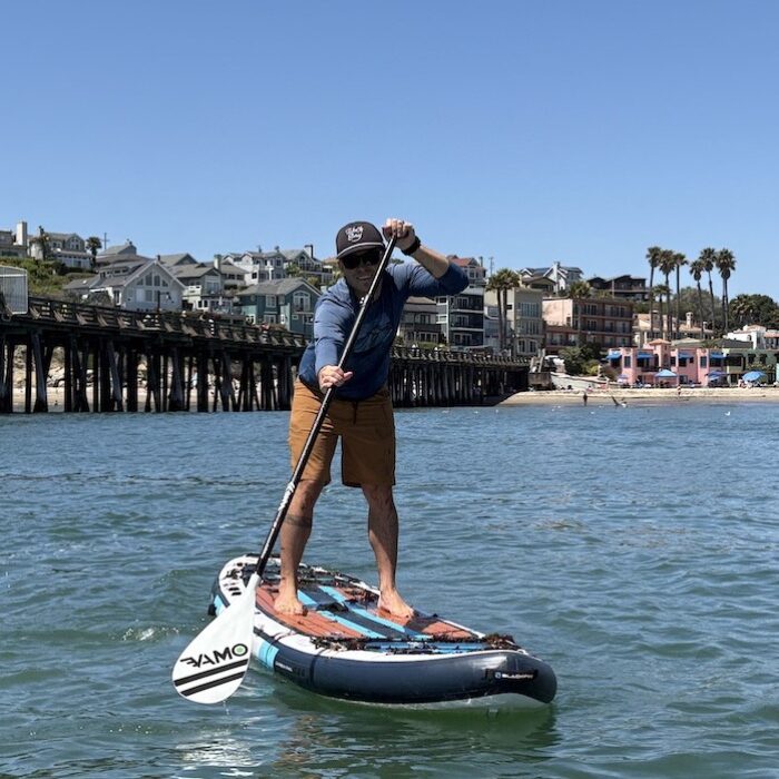 a man stand up paddling