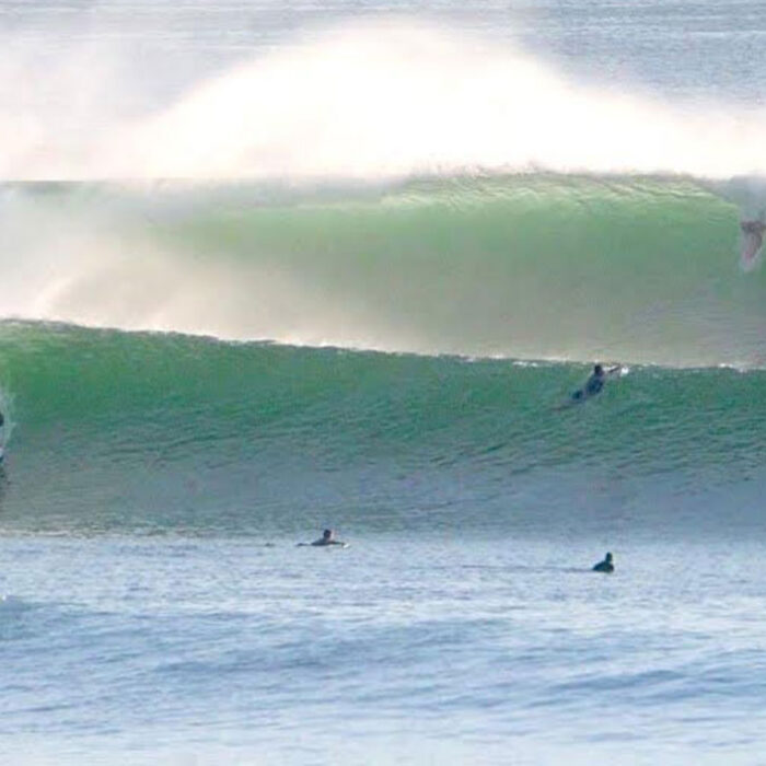 Surfers riding Impossibles on the Bukit Peninsula