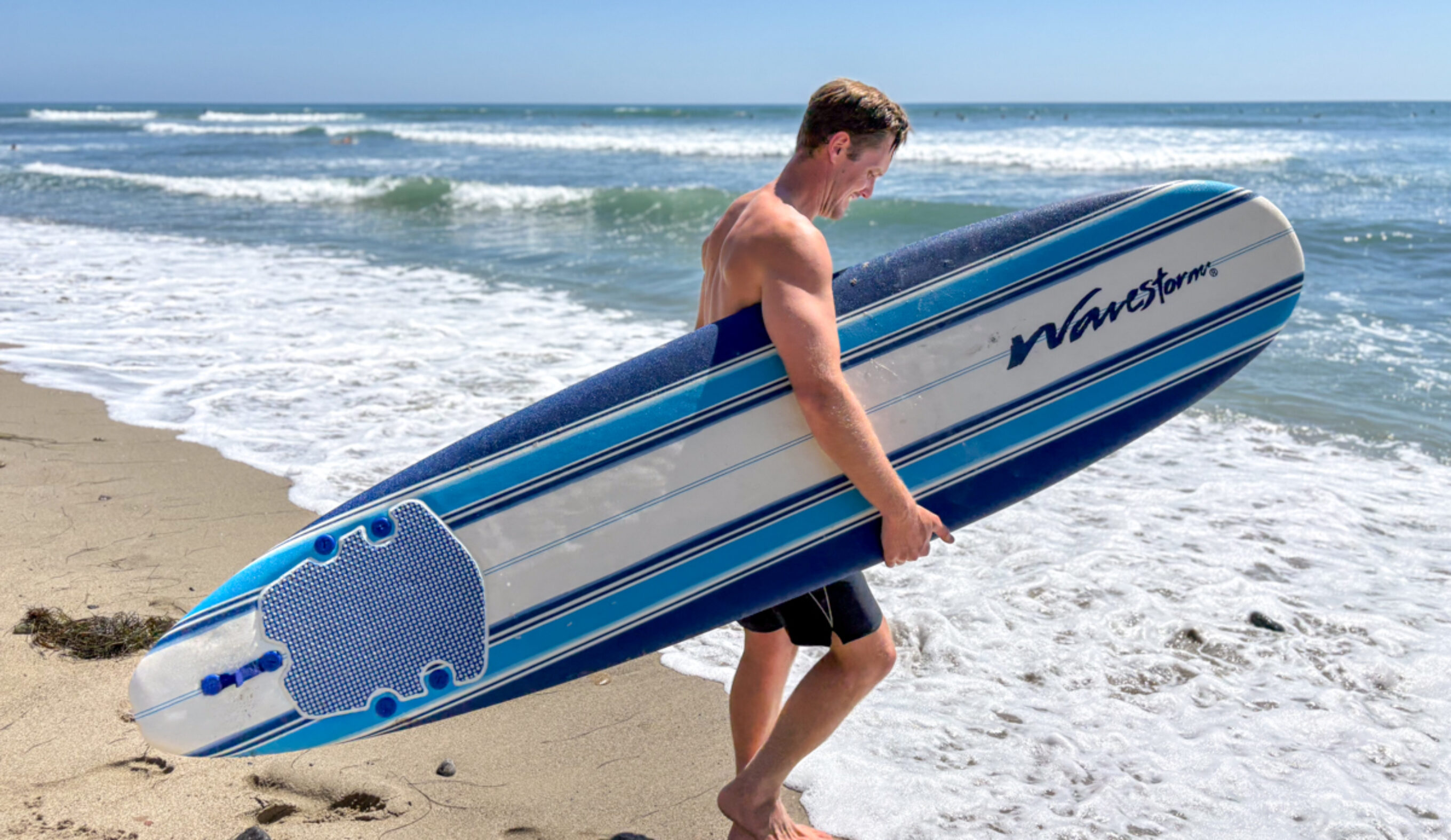 Dylan holds a wavestorm as he prepares to go surfing