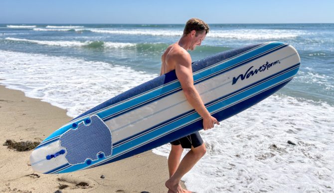 Dylan holds a wavestorm as he prepares to go surfing