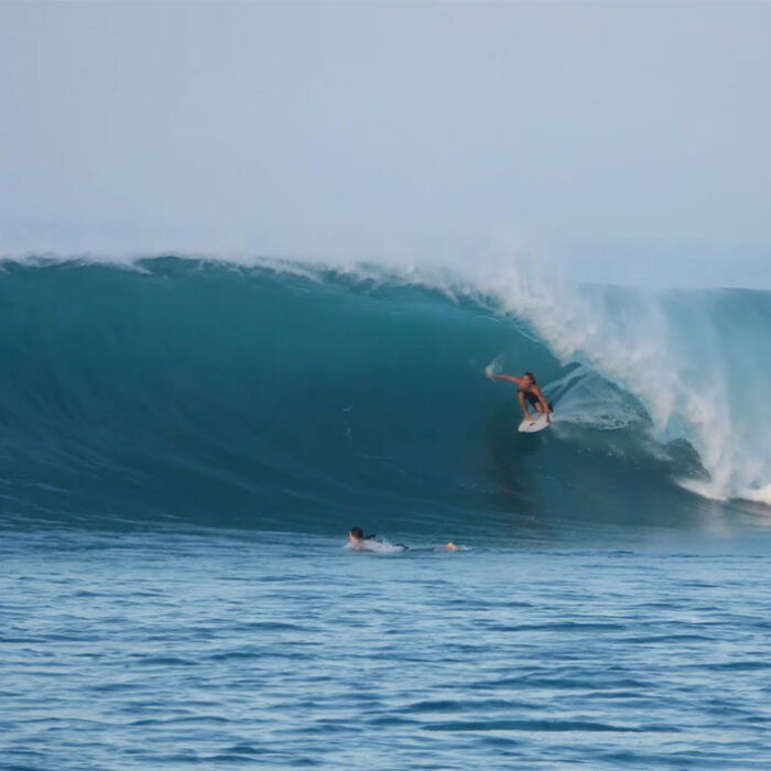 Man surfing on a wave in East Indonesia