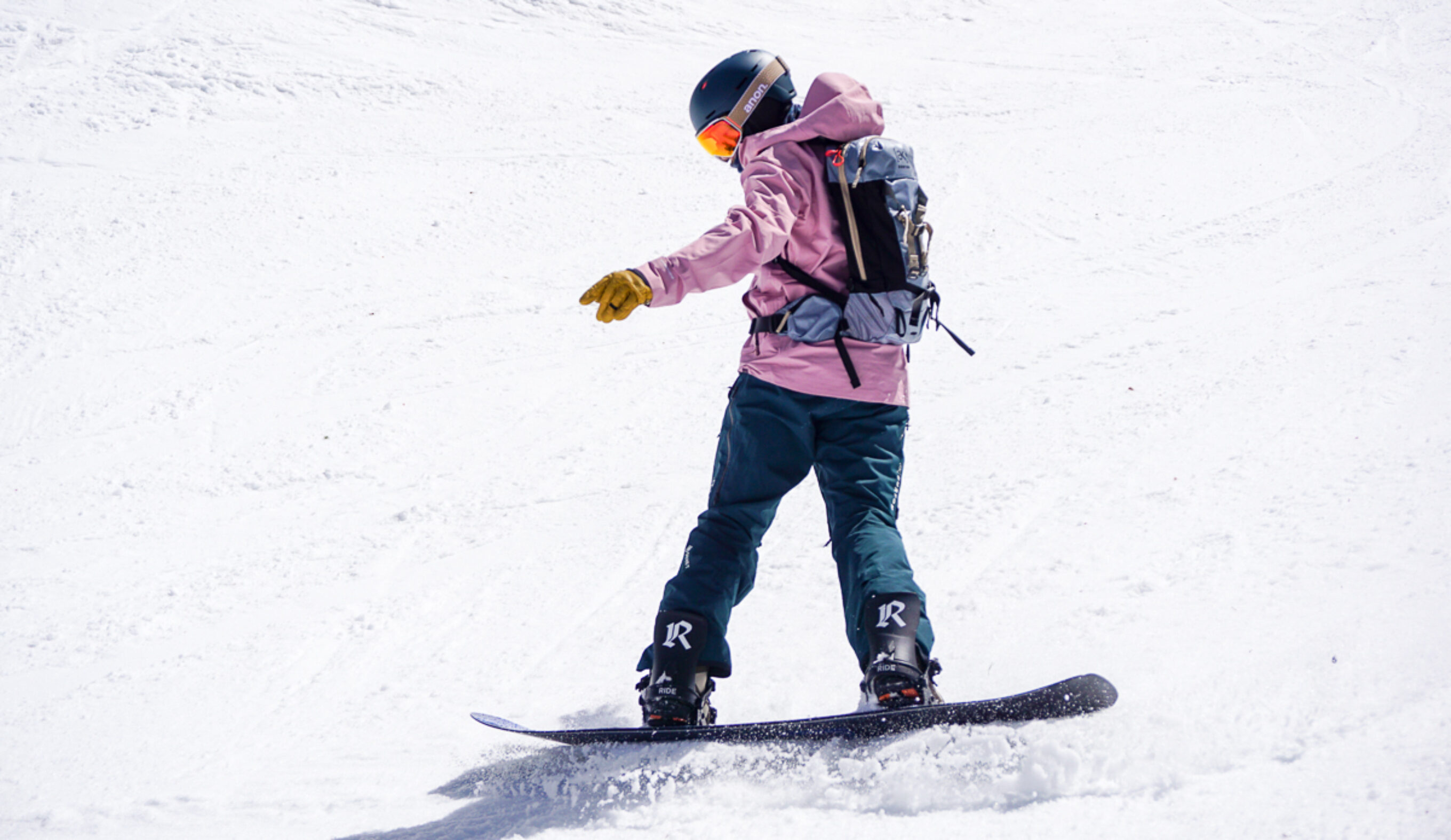 man turning on snowboard