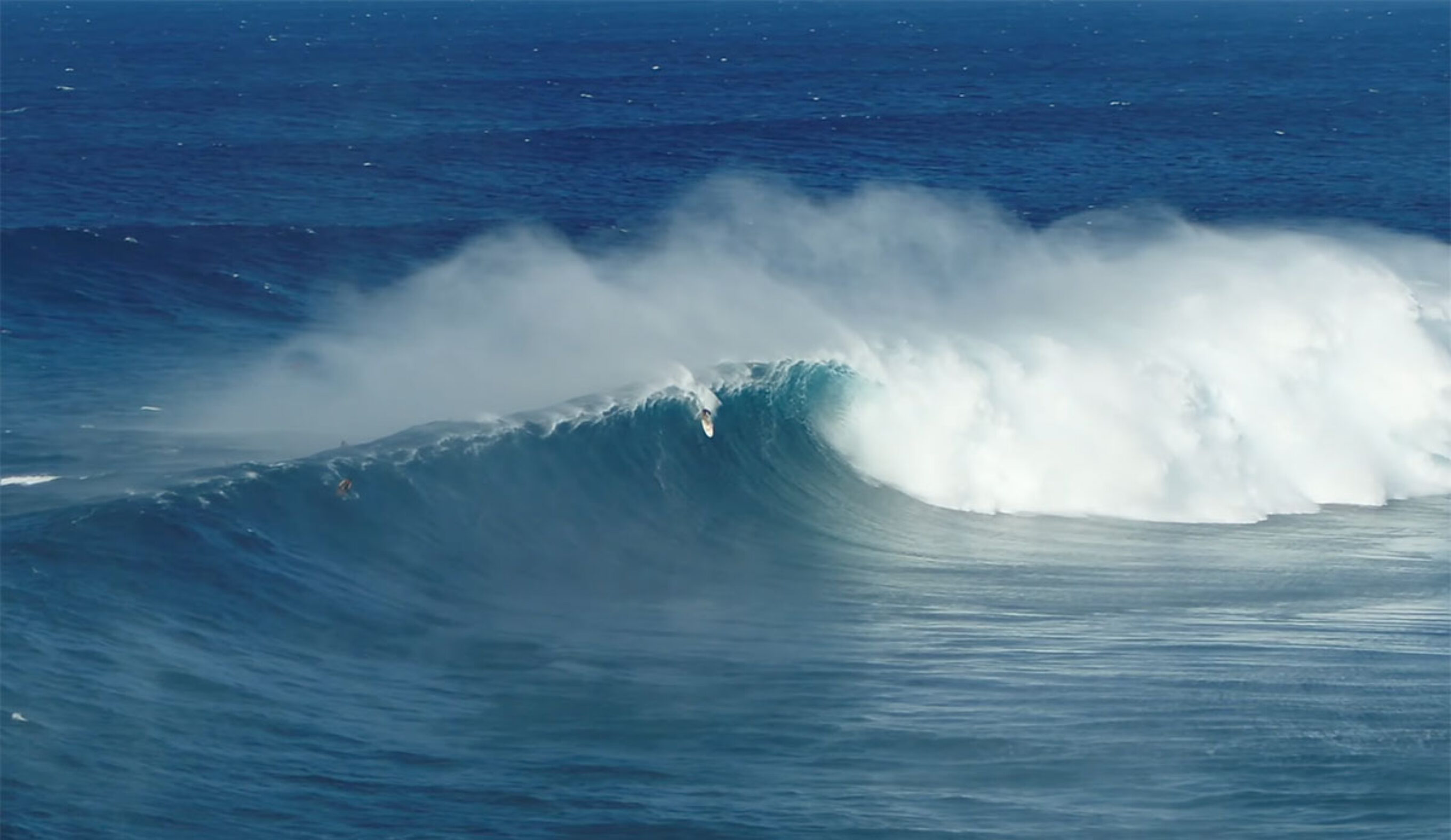Albee Layer surfing Jaws wave during the first swell of the season