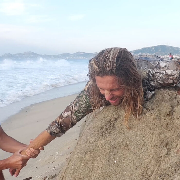 Blair Conklin attempting to reset his shoulder dislocation on a beach in Mexico