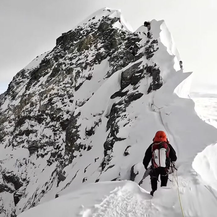 Man climbing to the summit of Mount Everest
