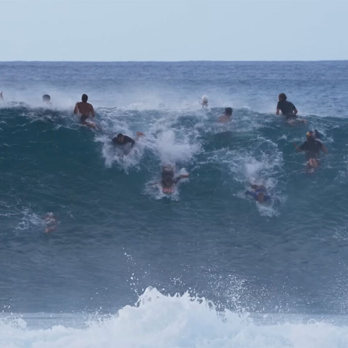 Jamie O'Brien surfing Pipeline in a big crowd