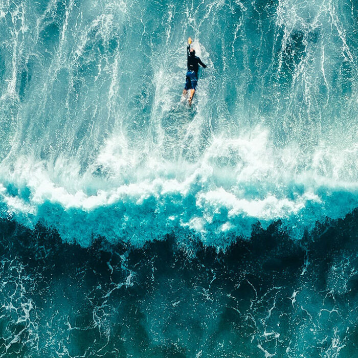 man paddling over waves like microscopic particles do