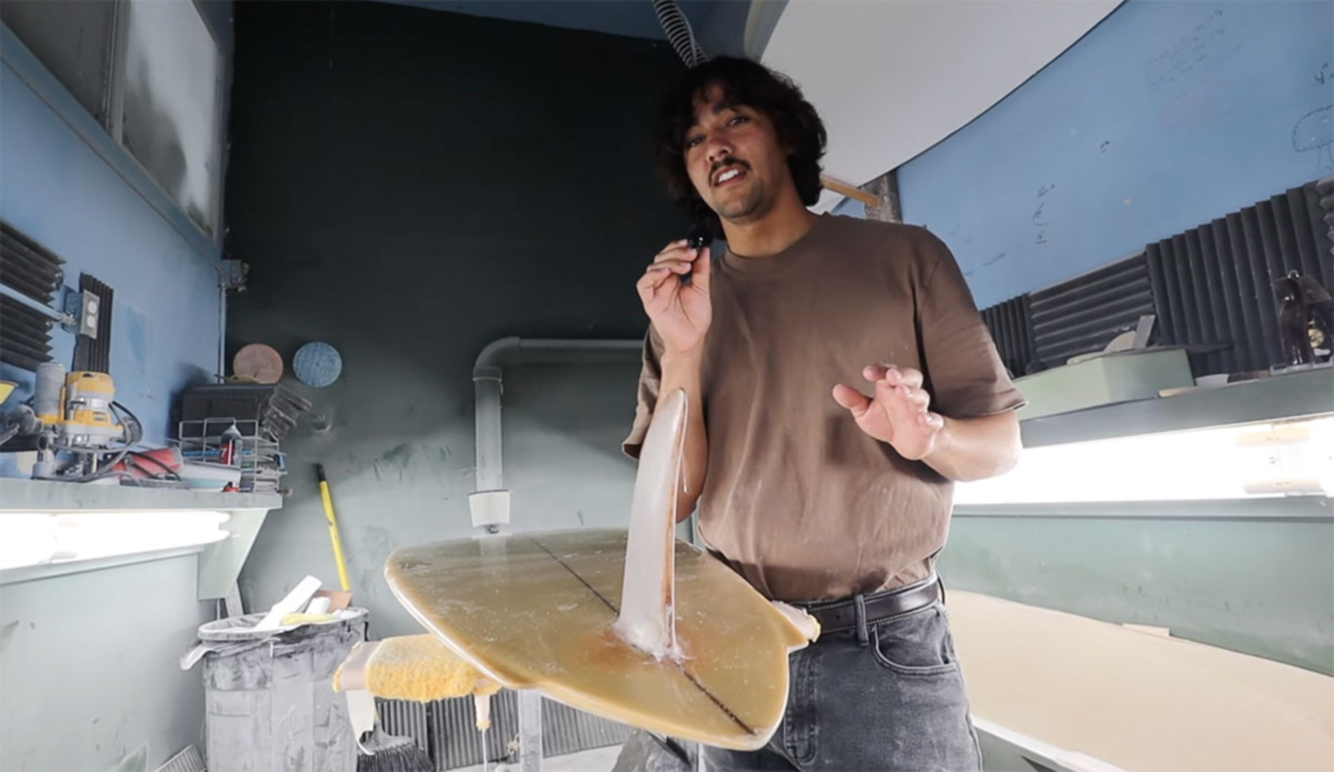 Zack Flores explaining how to shape a surfboard tail with a Steve Lis surfboard as an example
