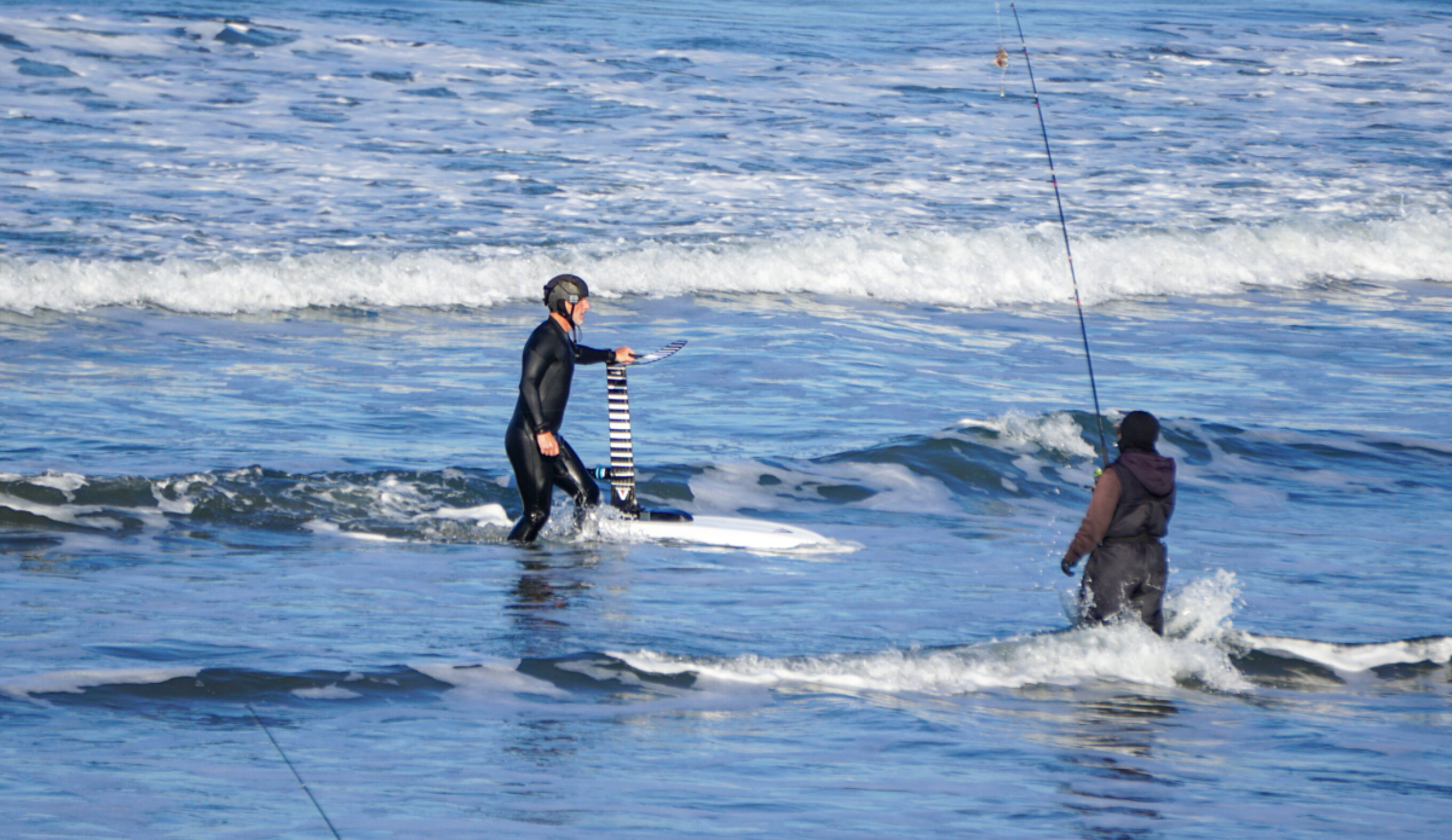 Bowen and a fisherman in the shorebreak