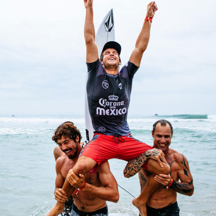 Jack Robinson being chaired to the beach
