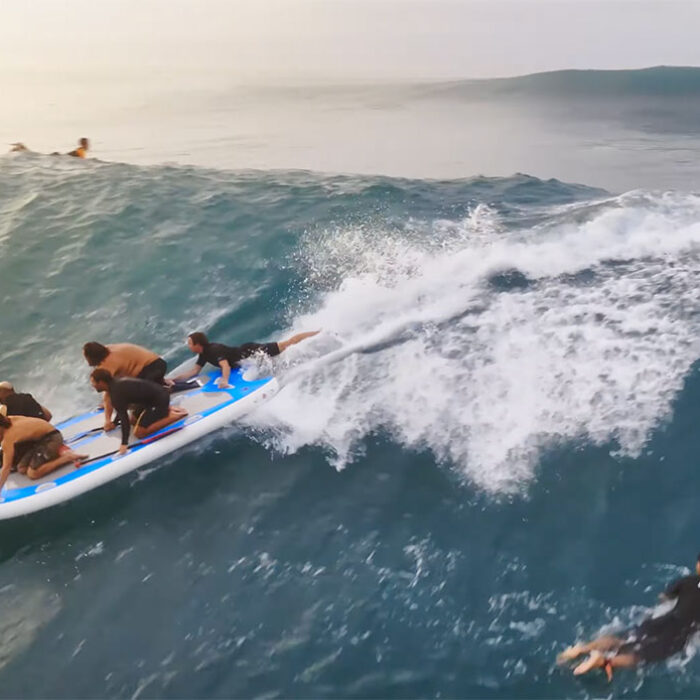 Jamie O'Brien steering a SUPsquatch at Sunset Beach