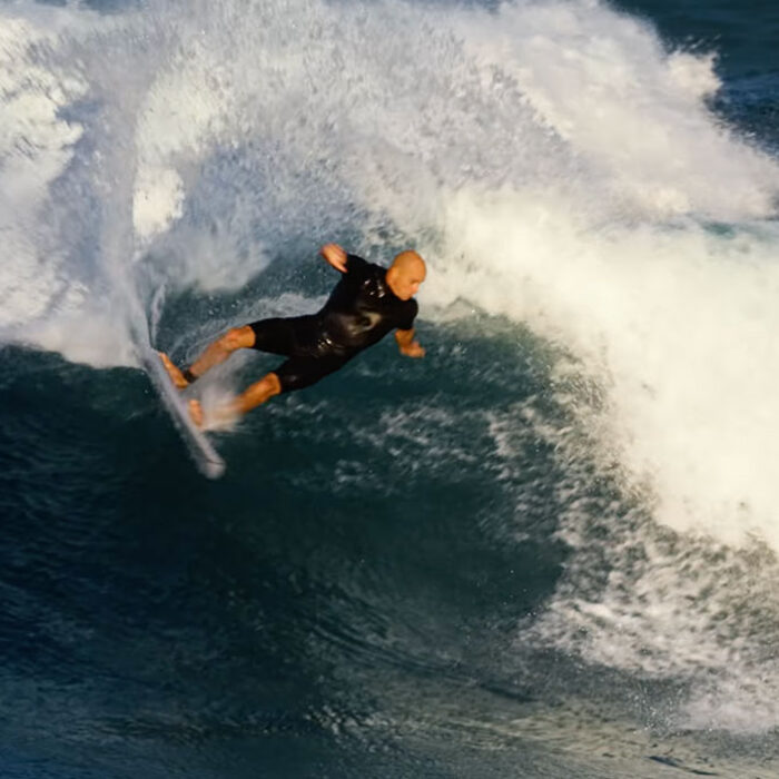 Kelly Slater surfing D Bah on a twin fin surfboard