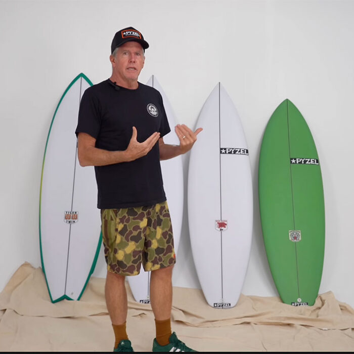Pyzel standing in front of the Tiger family of surfboards