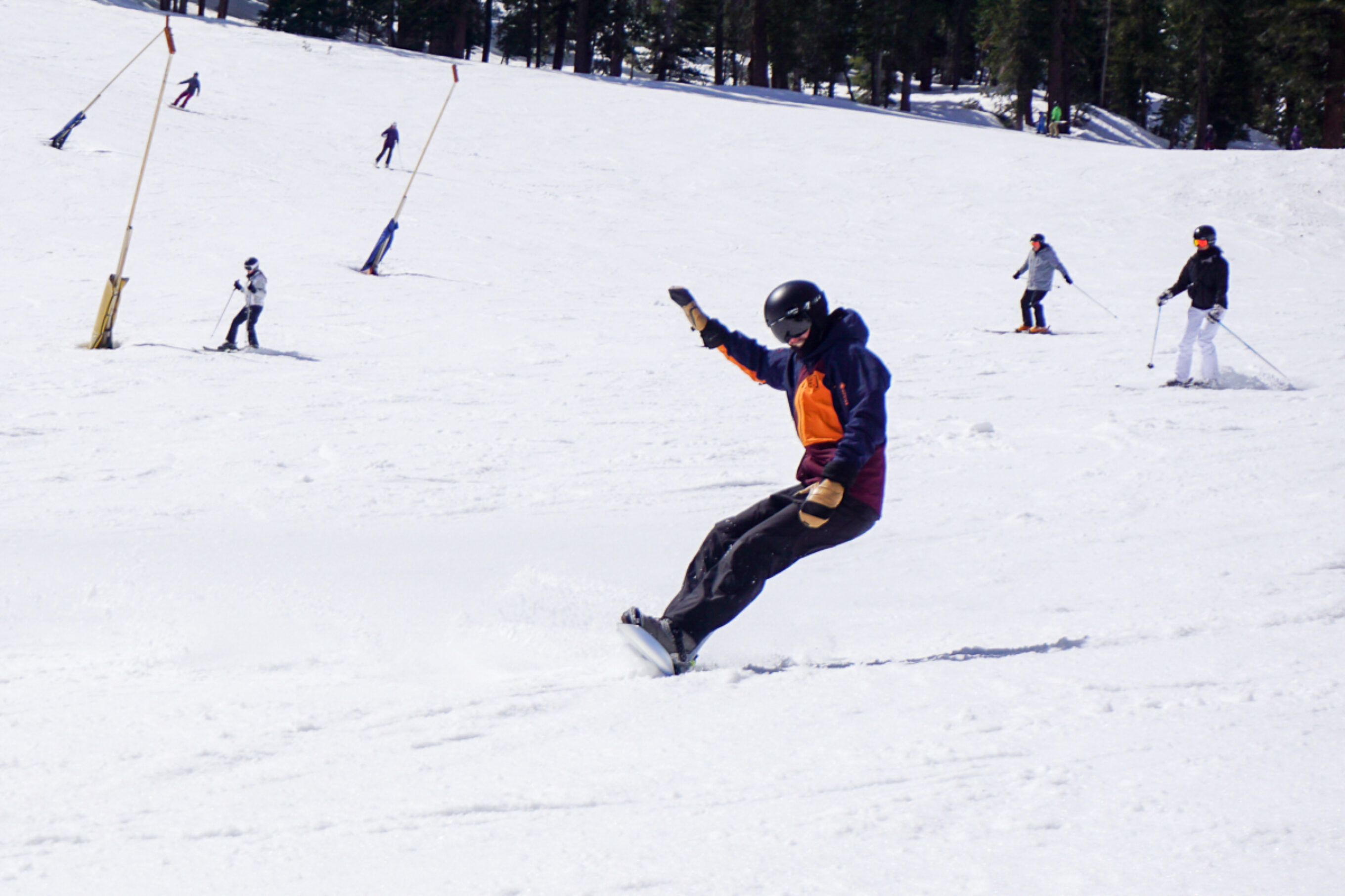 man carving on snowboard