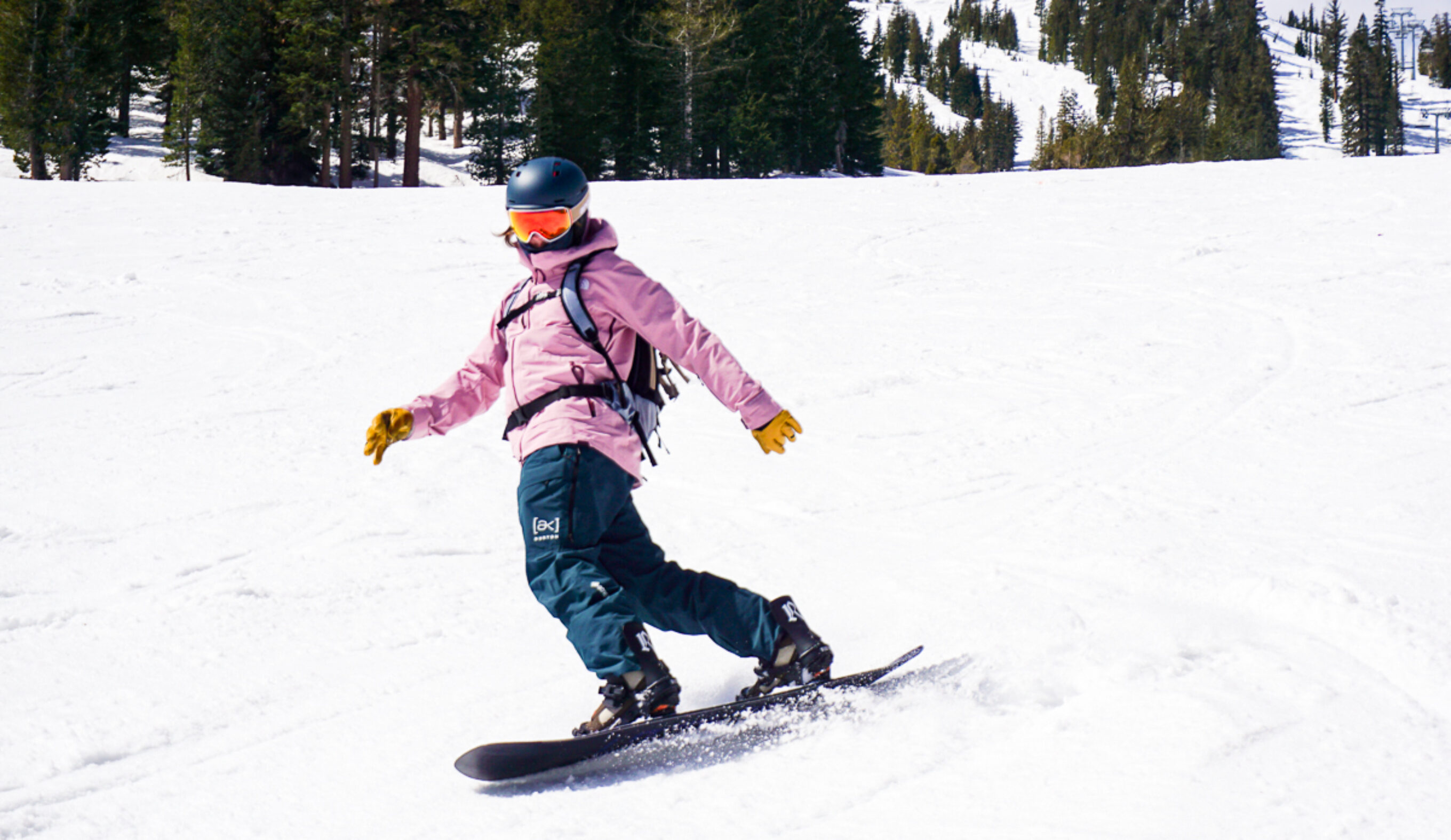 man carving on snowboard