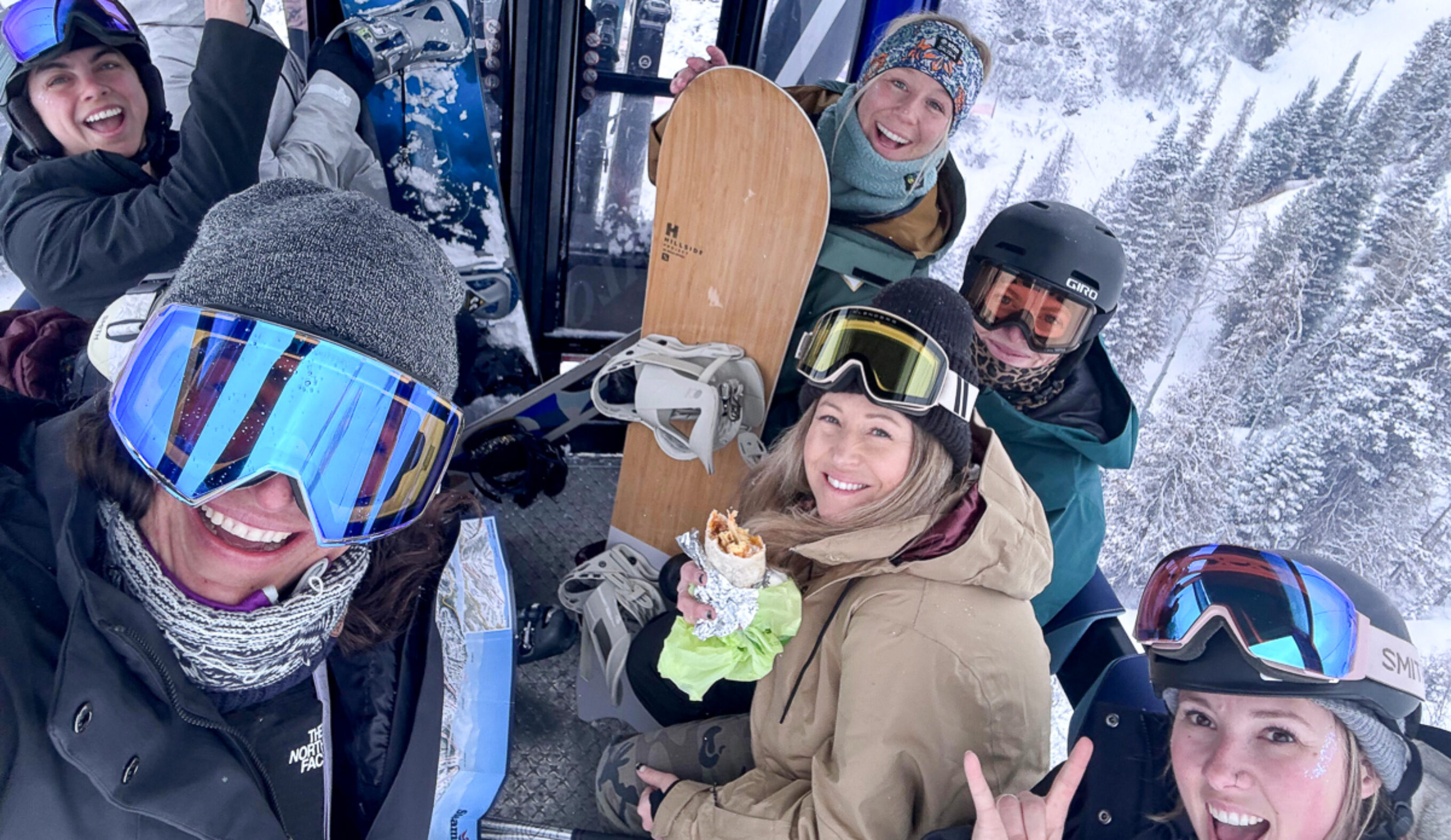 women snowboarders in a gondola