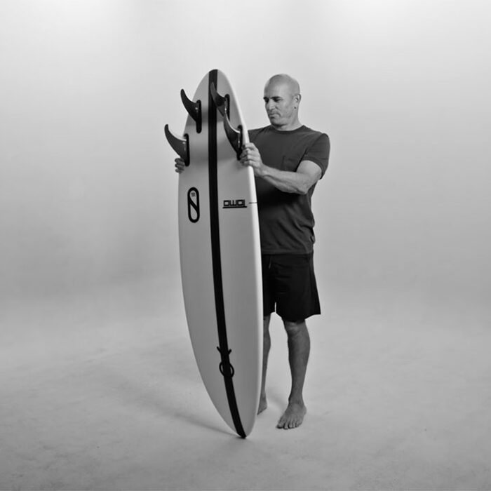 Kelly Slater holding new firewire surfboard, the Mindcraft