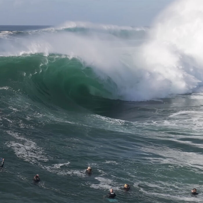 Cape Solander wave with surfingers in front of it