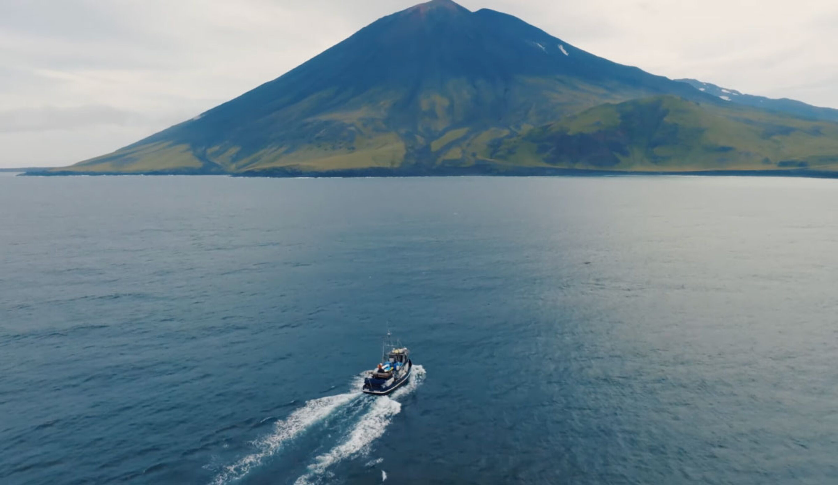 Boat going towards Volcano Island in Alaska