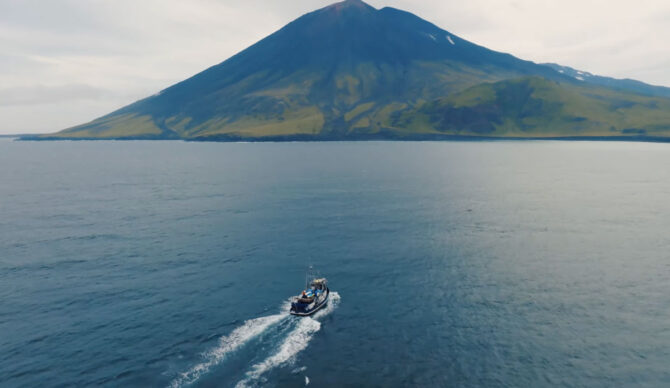 Boat going towards Volcano Island in Alaska