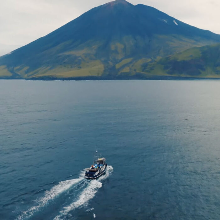 Boat going towards Volcano Island in Alaska