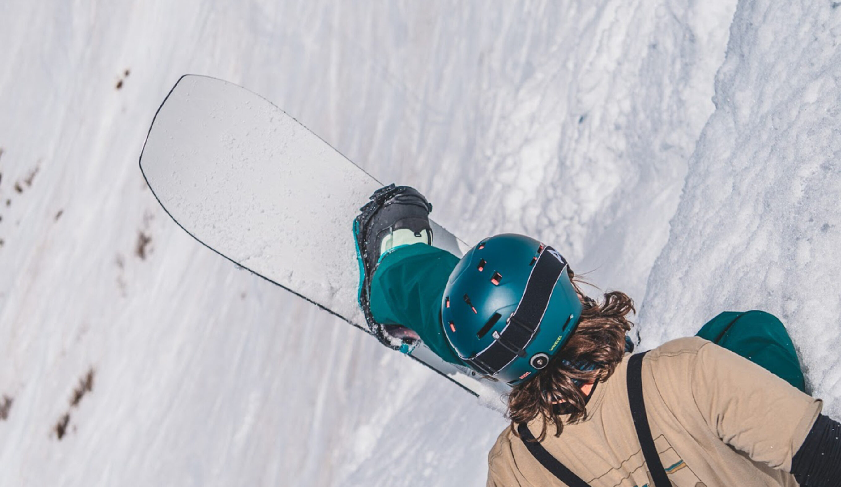 man sitting with snowboard up in air