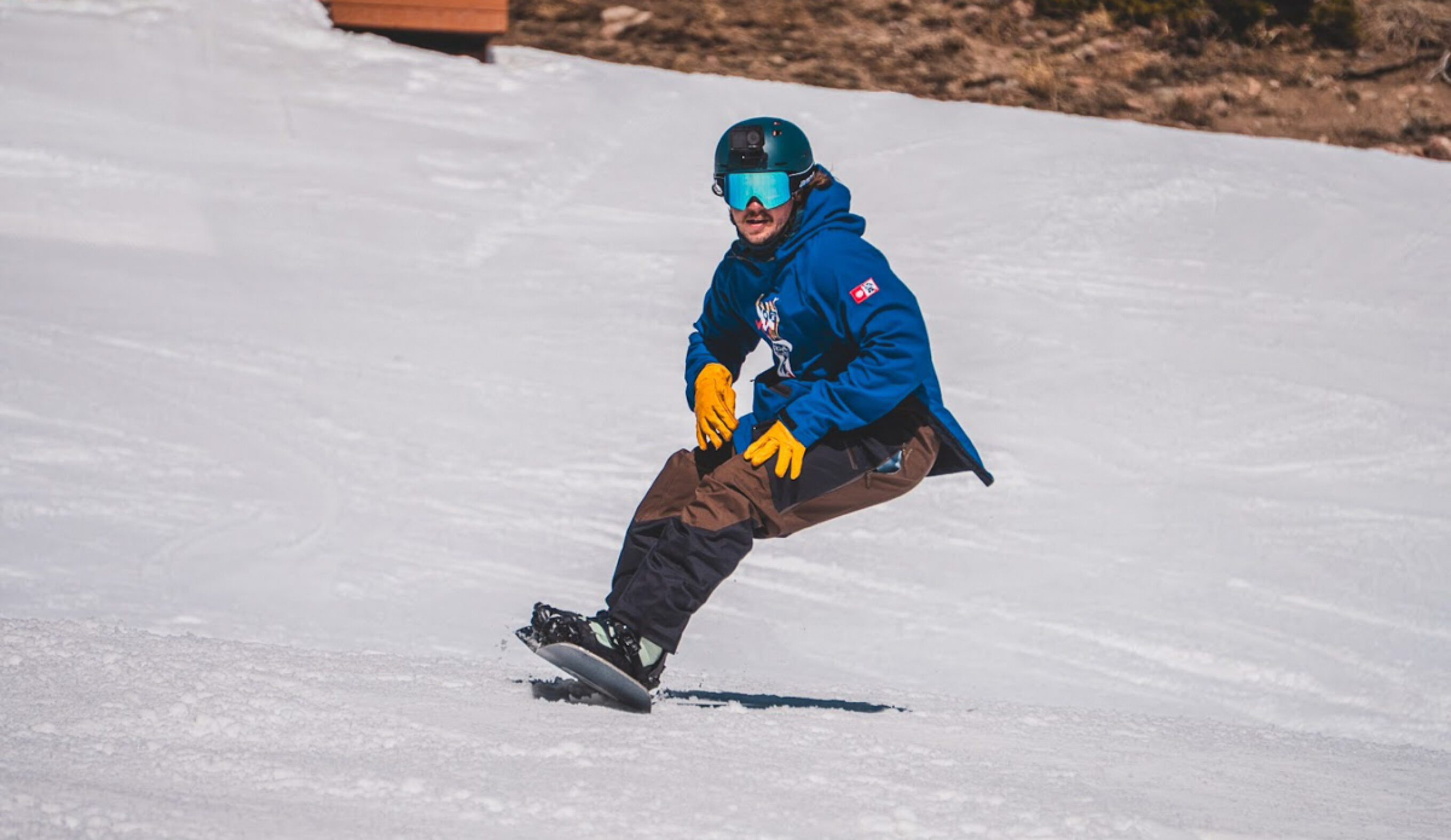 man carving on snowboard