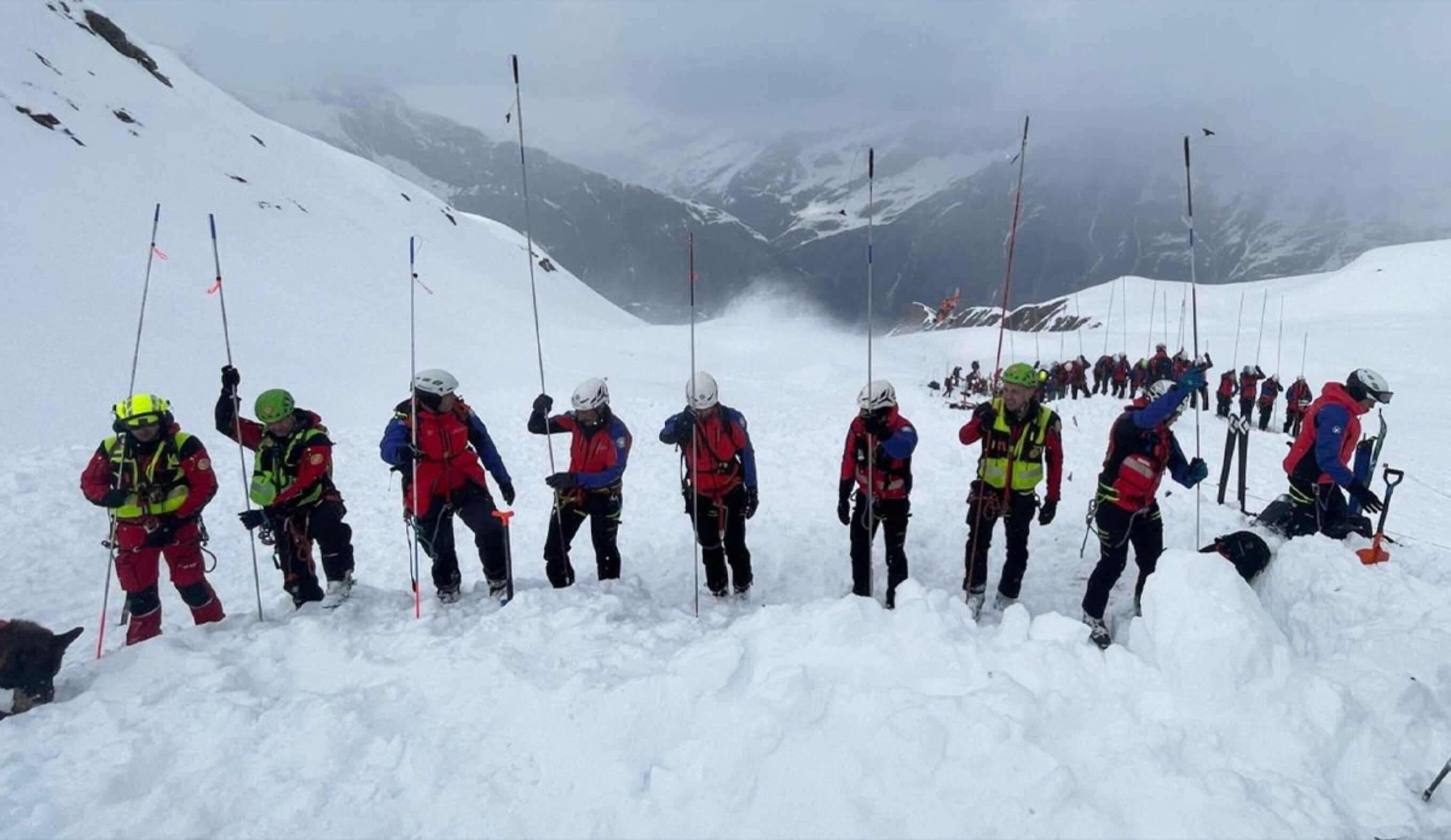 Italian rescue workers comb the snow for buried skiers in the Italian Alps. Photo CNSAS