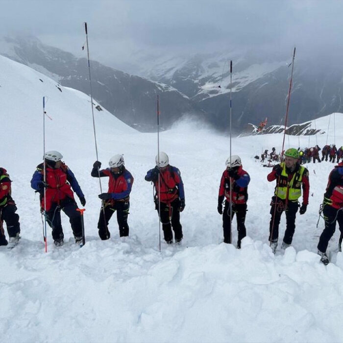 Italian rescue workers comb the snow for buried skiers in the Italian Alps. Photo CNSAS