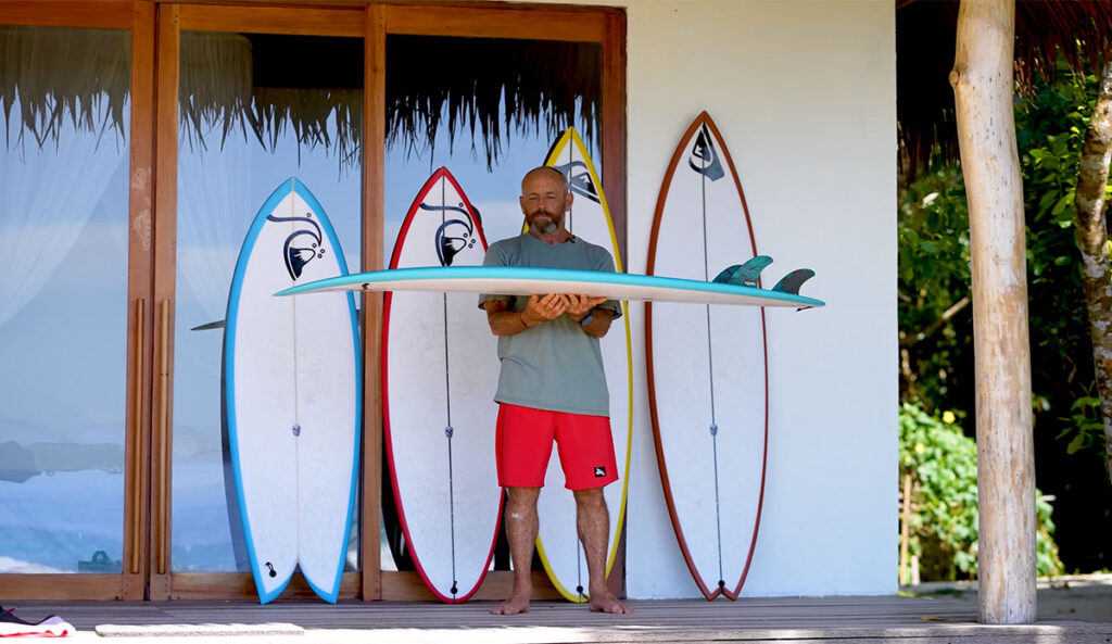 Tom Carroll with surfboards in Indonesia