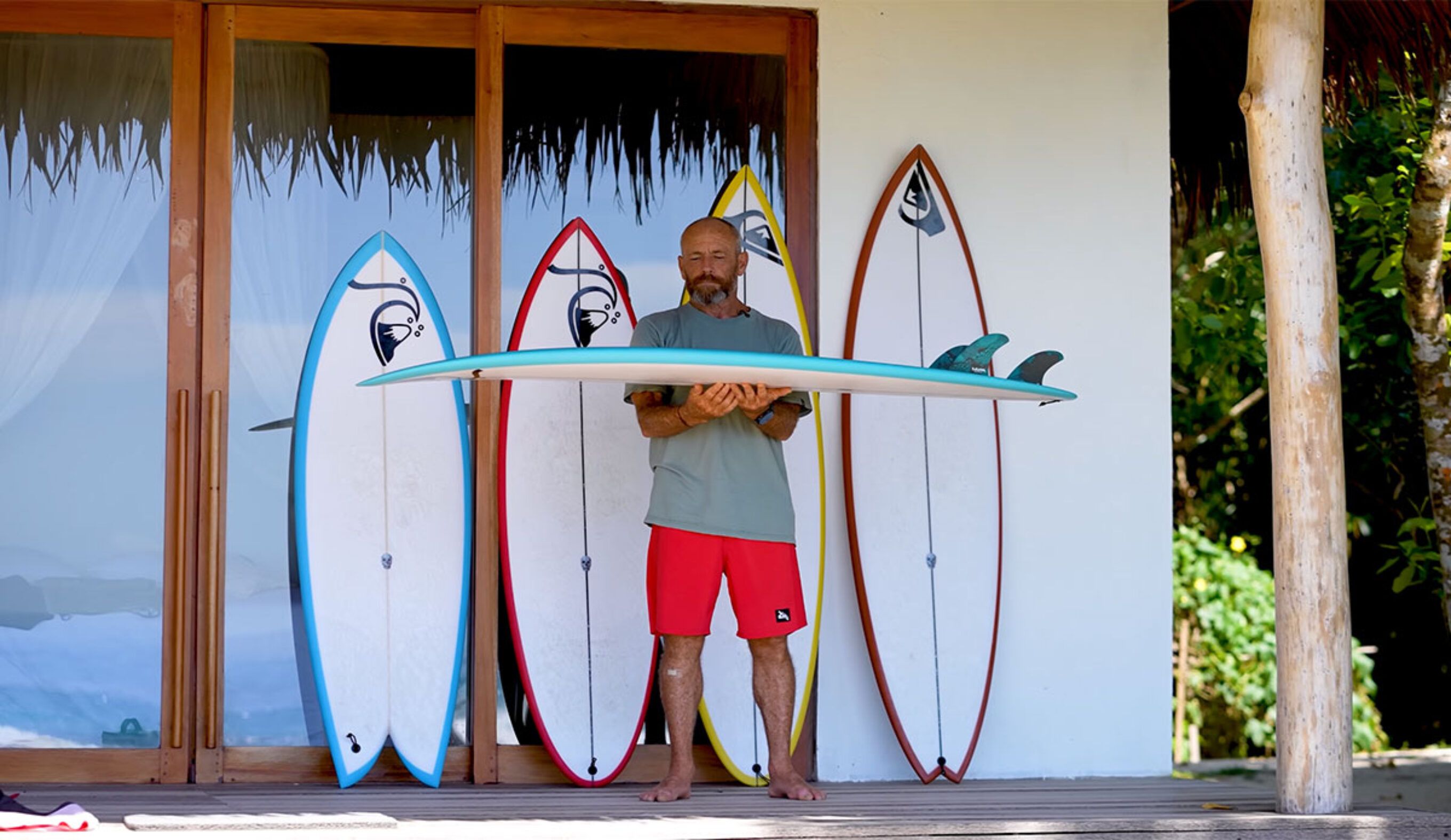Tom Carroll with surfboards in Indonesia