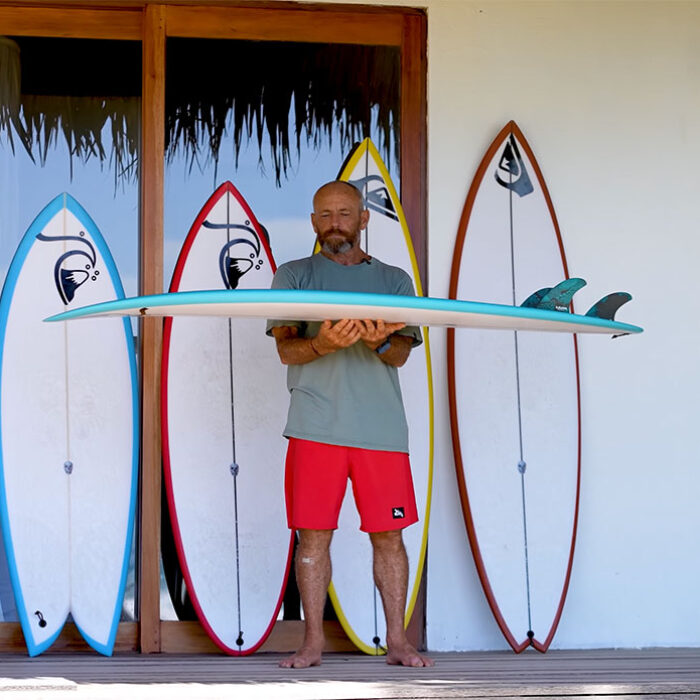 Tom Carroll with surfboards in Indonesia