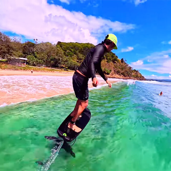 Adam Bennets surfing a foil close to shore