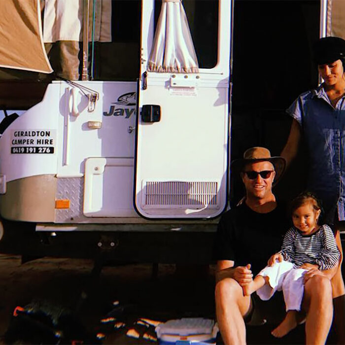 Taj Burrow sitting with his family