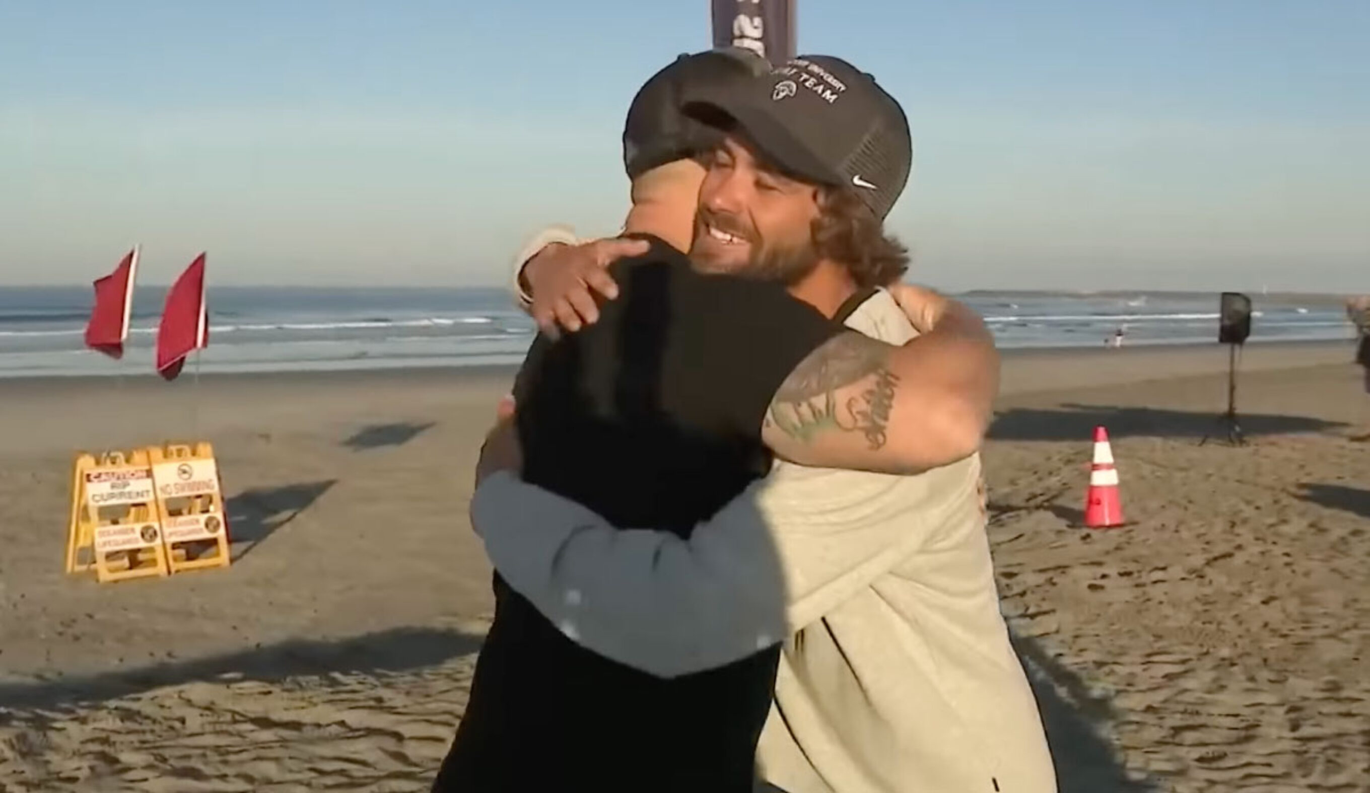 surf coach lucas Taub hugging a father he rescued