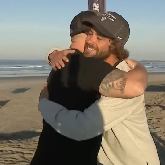 surf coach lucas Taub hugging a father he rescued