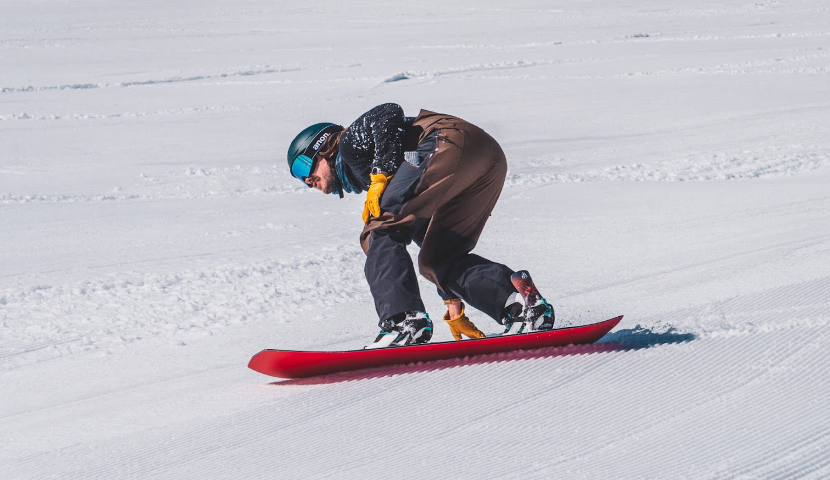 man turning on snowboard