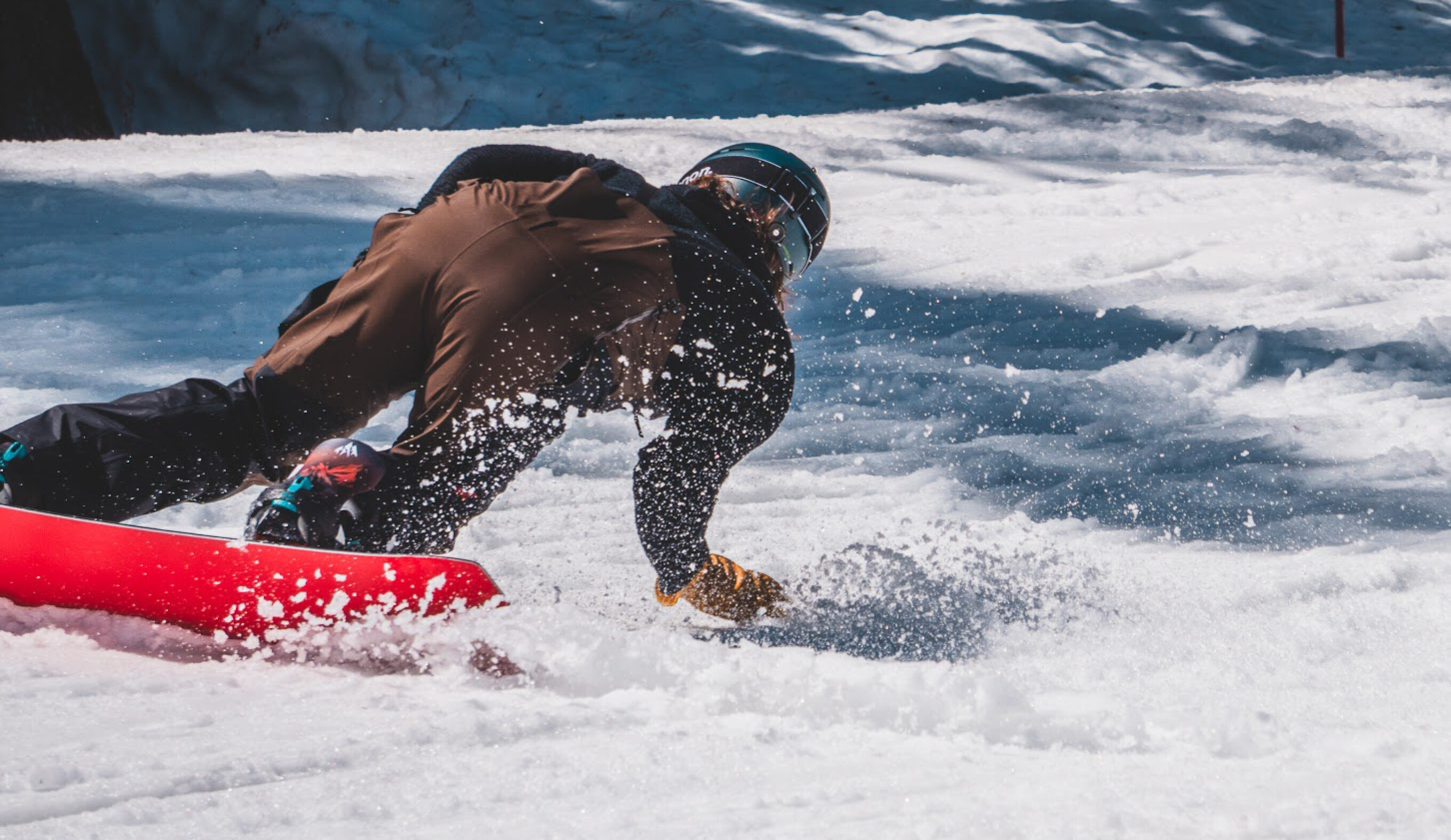 man carving on snowboard