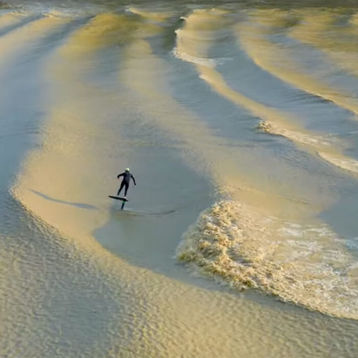 Adam Bennetts on a foil surfboard on a tidal bore in France