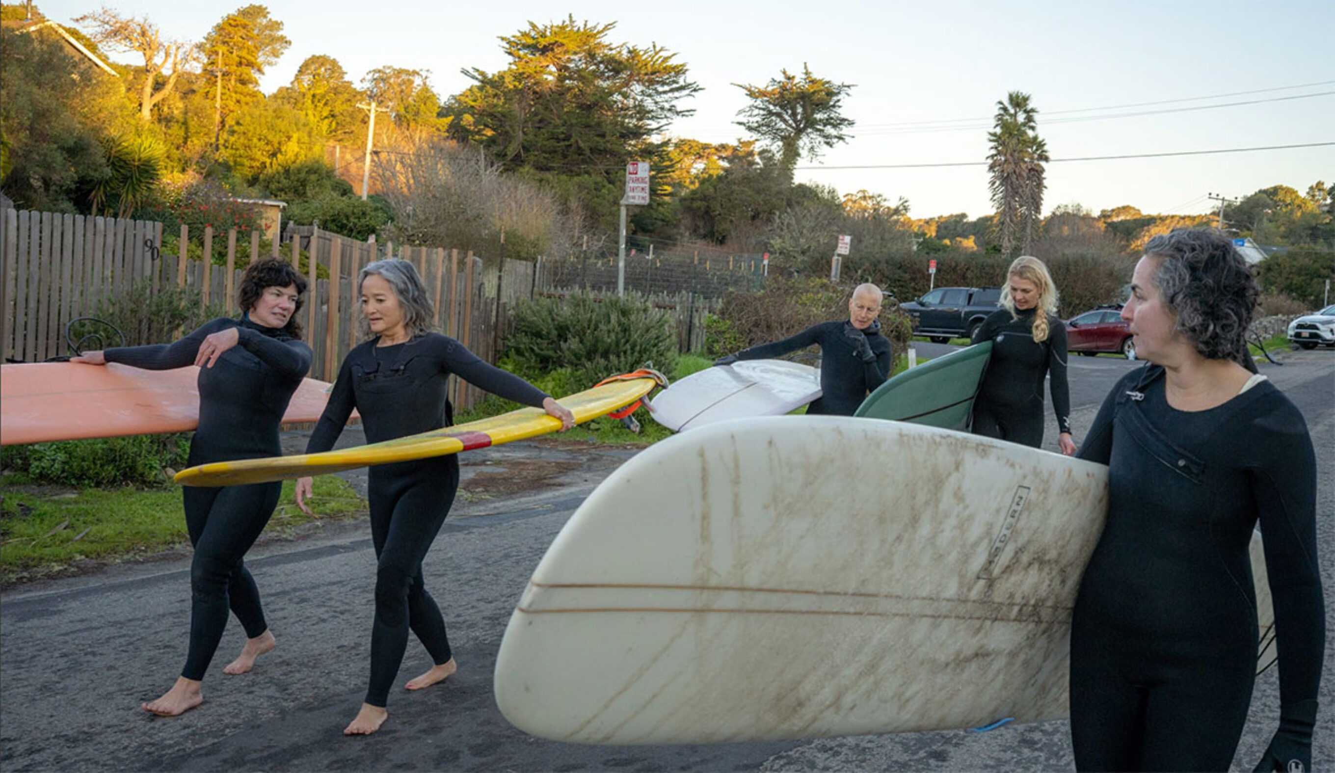 Danielle Cass surfing with group of friends