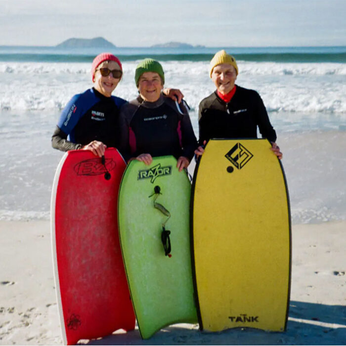 The Granny Grommets on a beach with boogie boards