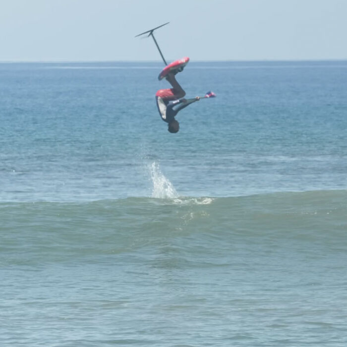 Kai Lenny doing a backflip on a SUP foil