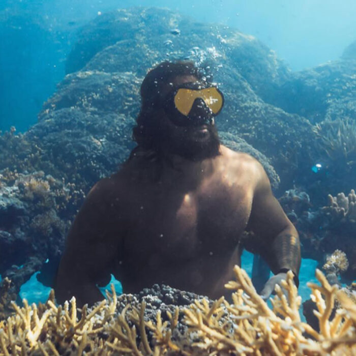 Jason Momoa by a coral reef